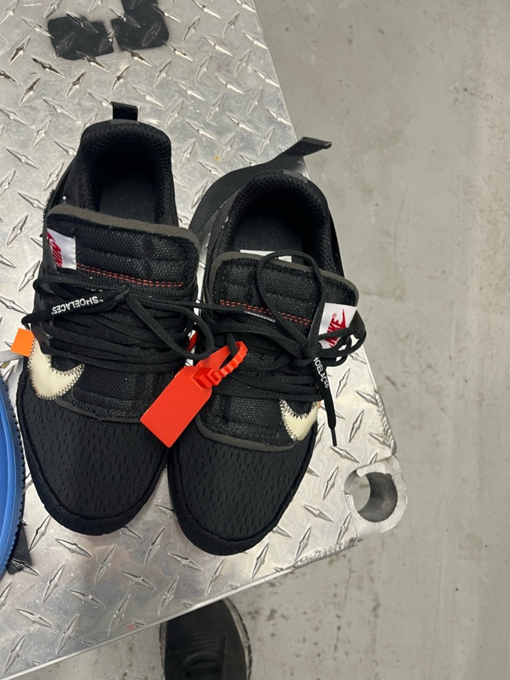 Nike Black Sneakers with Cream Swoosh and Orange Zip Tag